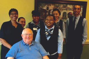 A birthday to remember! The South Village Dining Staff helps Jim Bundy celebrate in style.
