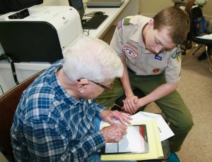 Scout, David Bass helping Bob Gardner learn a few new tricks on his iPad