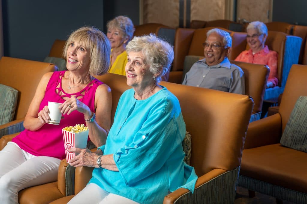 senior living in raleigh, seniors in a theater