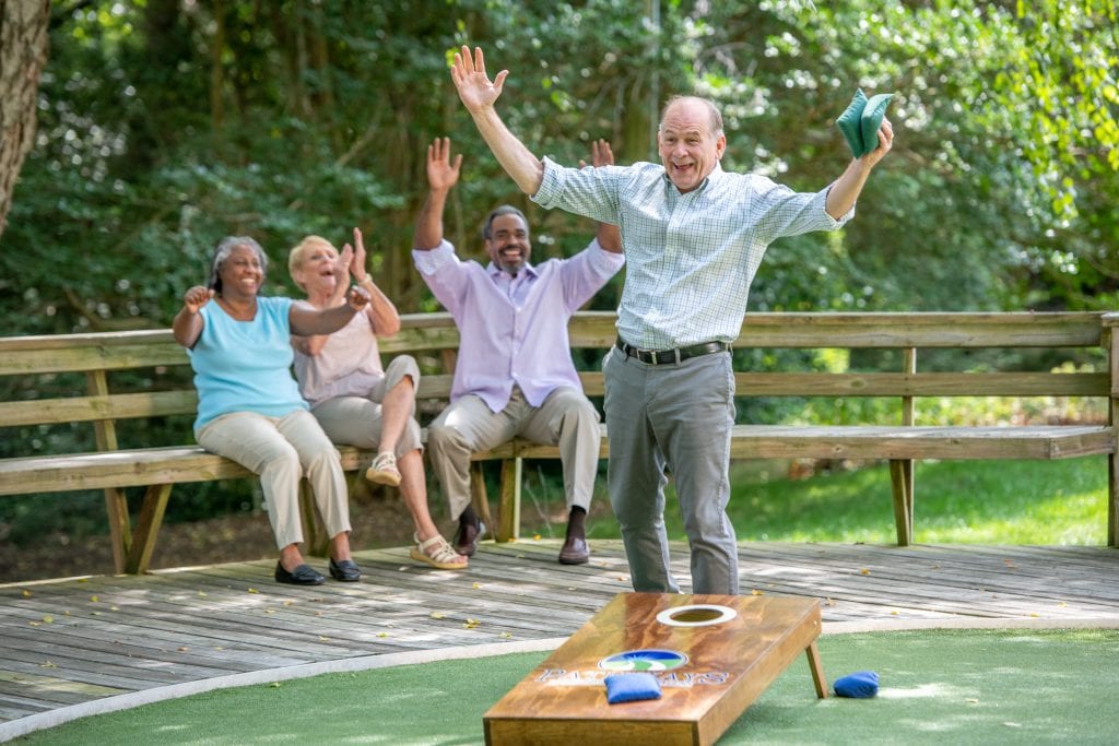 seniors playing cornhole and enjoying NC retirement 